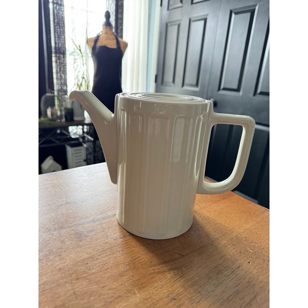 vintage white coffee pot is likely from the Art Deco or Bauhaus era